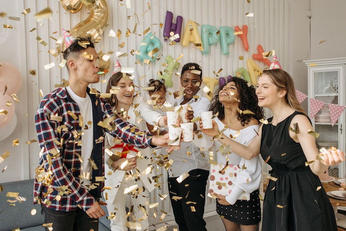 confetti being thrown by friends as a birthday photoshoot idea