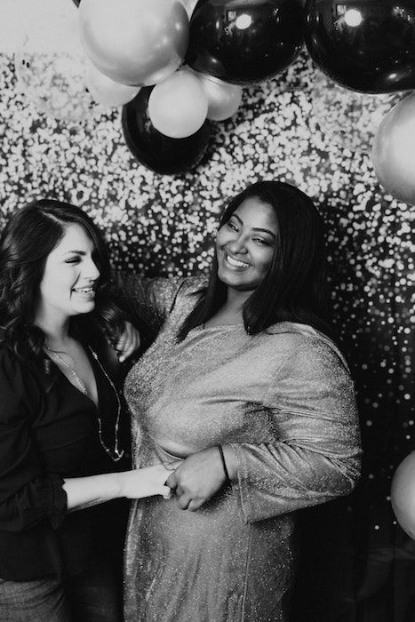 girls posing in photo booth for a birthday