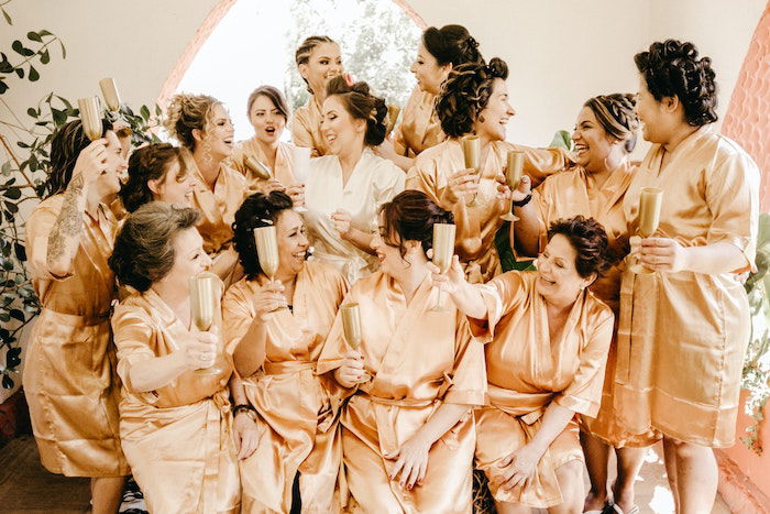 a group of women in the same brown dress as a birthday photoshoot idea