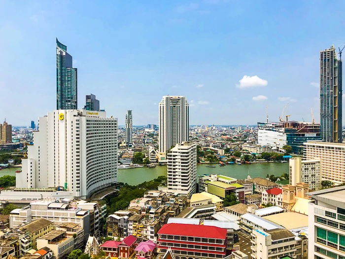 Cityscape photo of modern city with river running across the frame