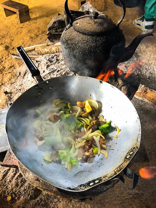 Hot wok full of meat and vegetables being stir fried