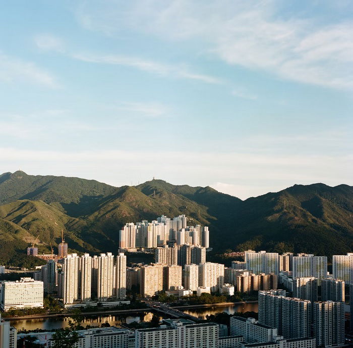 Landscape city below green mountians