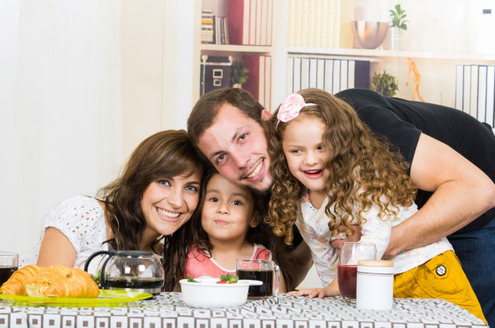 Portrait of a family sitting at a table