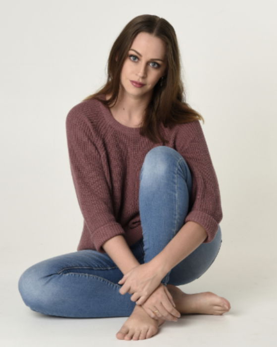 Woman posed for a photo sitting on the floor