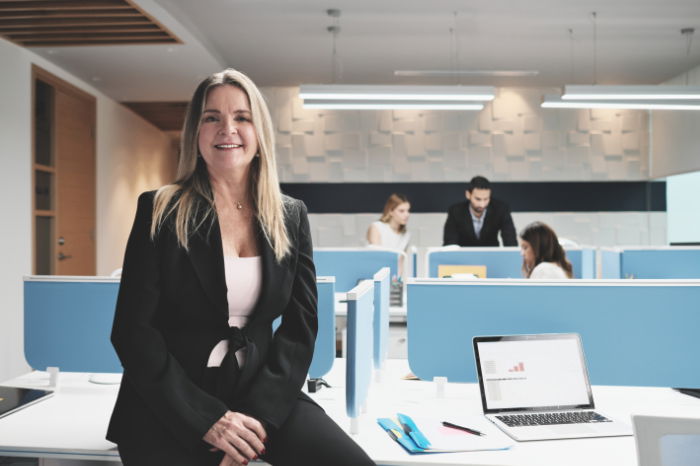 Woman sitting on desk posing for a photography