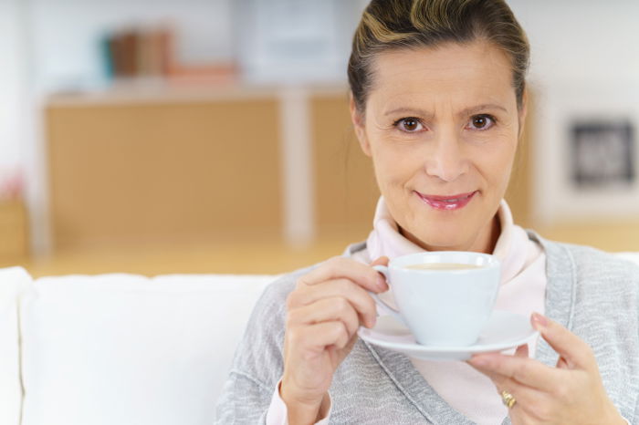 Woman sitting with cup of tea