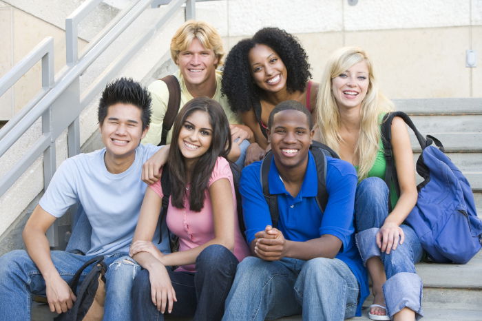 Young people posing while sitting on steps