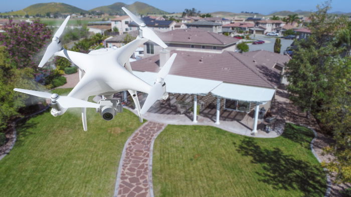 Drone flying over a house, showing the house and garden