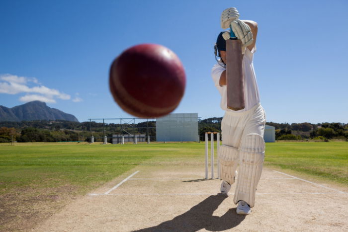 Dramatic shot of a cricket batter hitting the ball straight at the camera