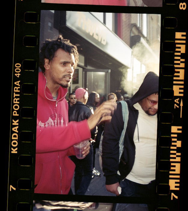 negative scanned with perferation, image shows two men in the city