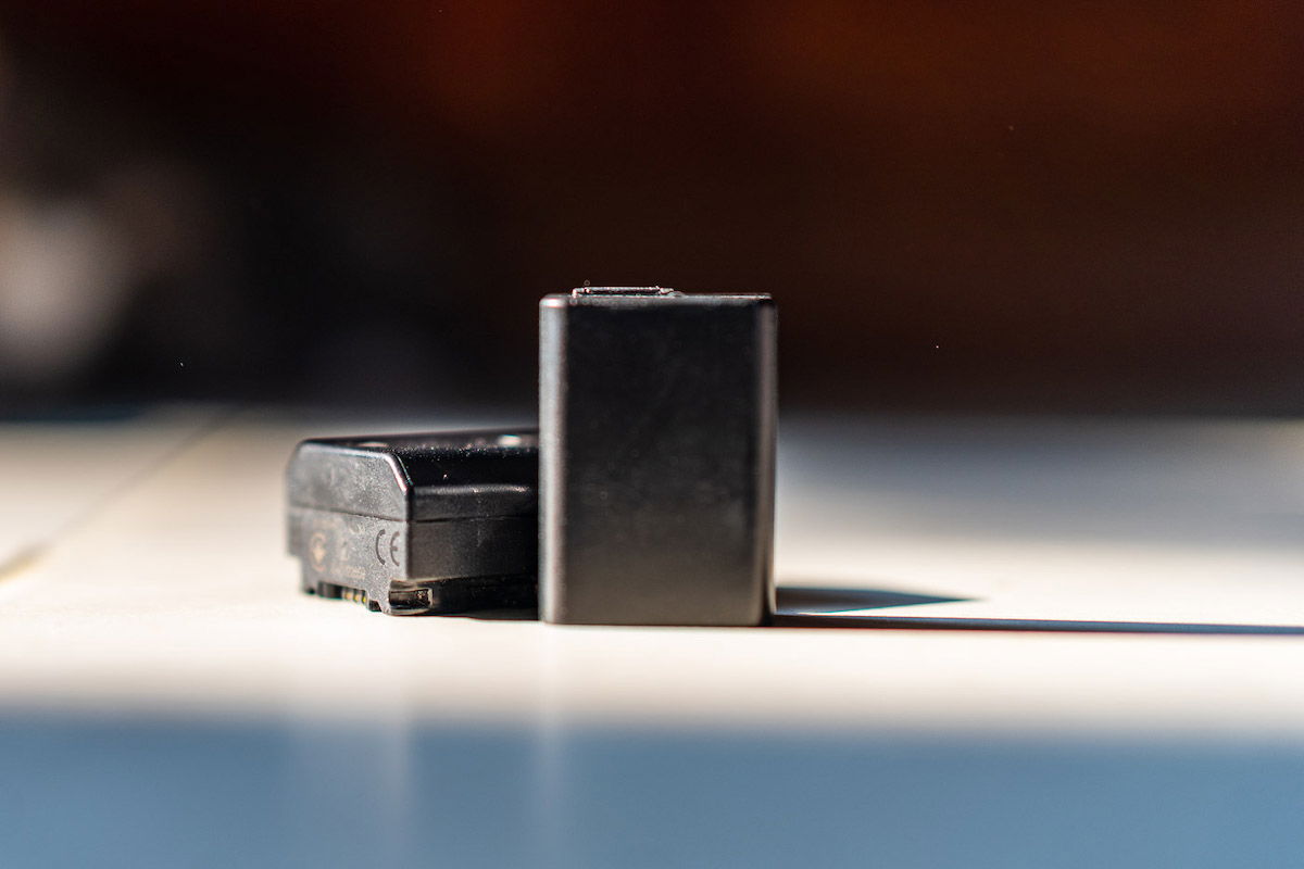 Two third-party camera batteries on a table