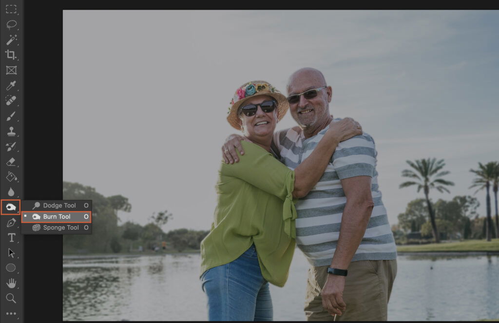 An elderly couple embracing at a lake, with a software interface overlaying the image. 