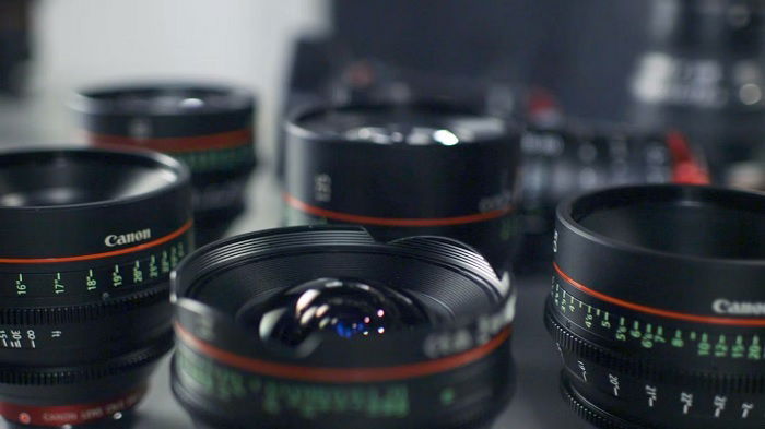 Several canon lenses standing on their ends