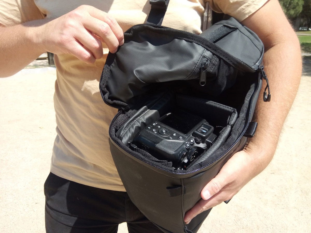 Using side access to retrieve the camera from the backpack