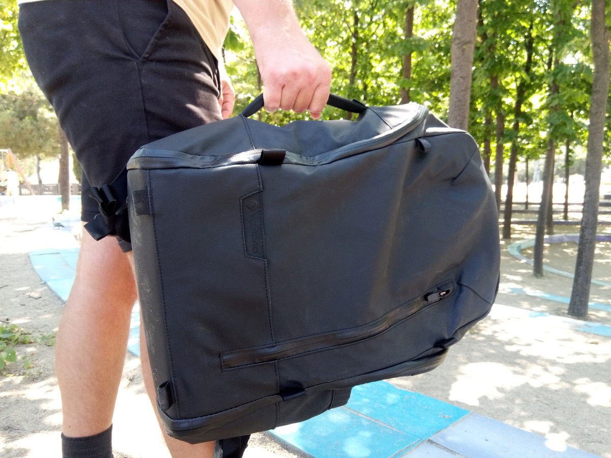 Bag being carried by the side handle