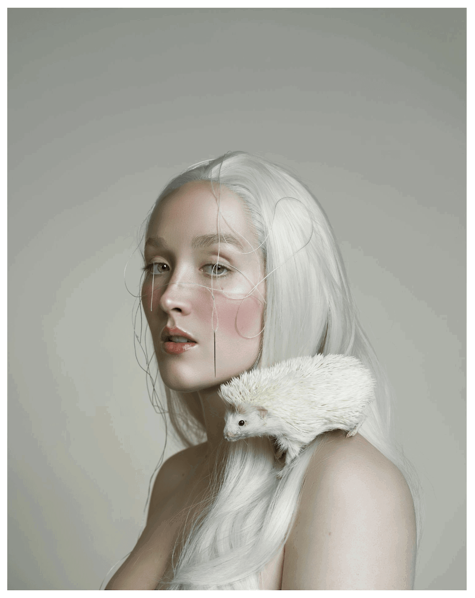 Portrait of a woman with a hedgehog on her shoulder