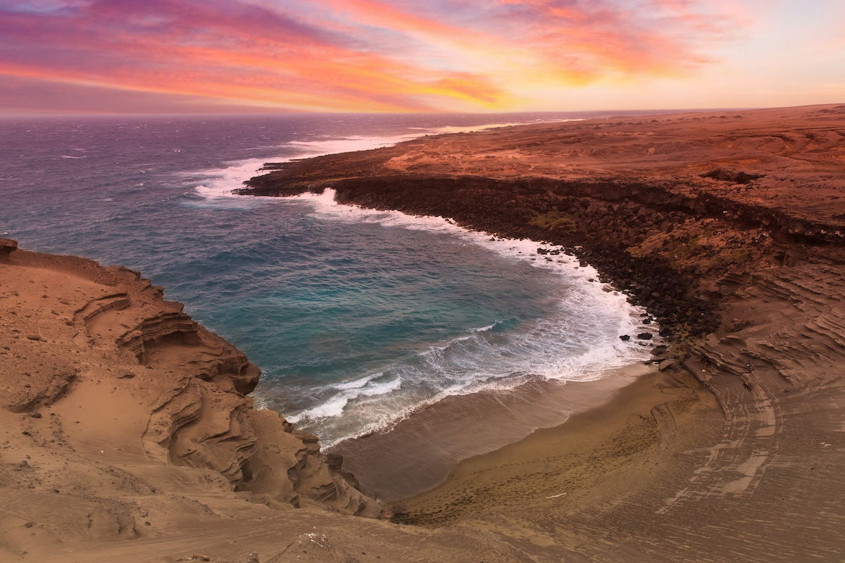 Brightly edited image of sky, ocean shoreline, and inlet