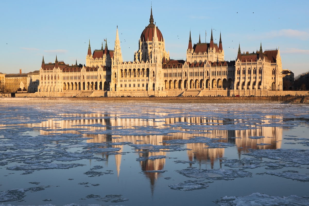 Edited image of old government building with river reflection at golden hour