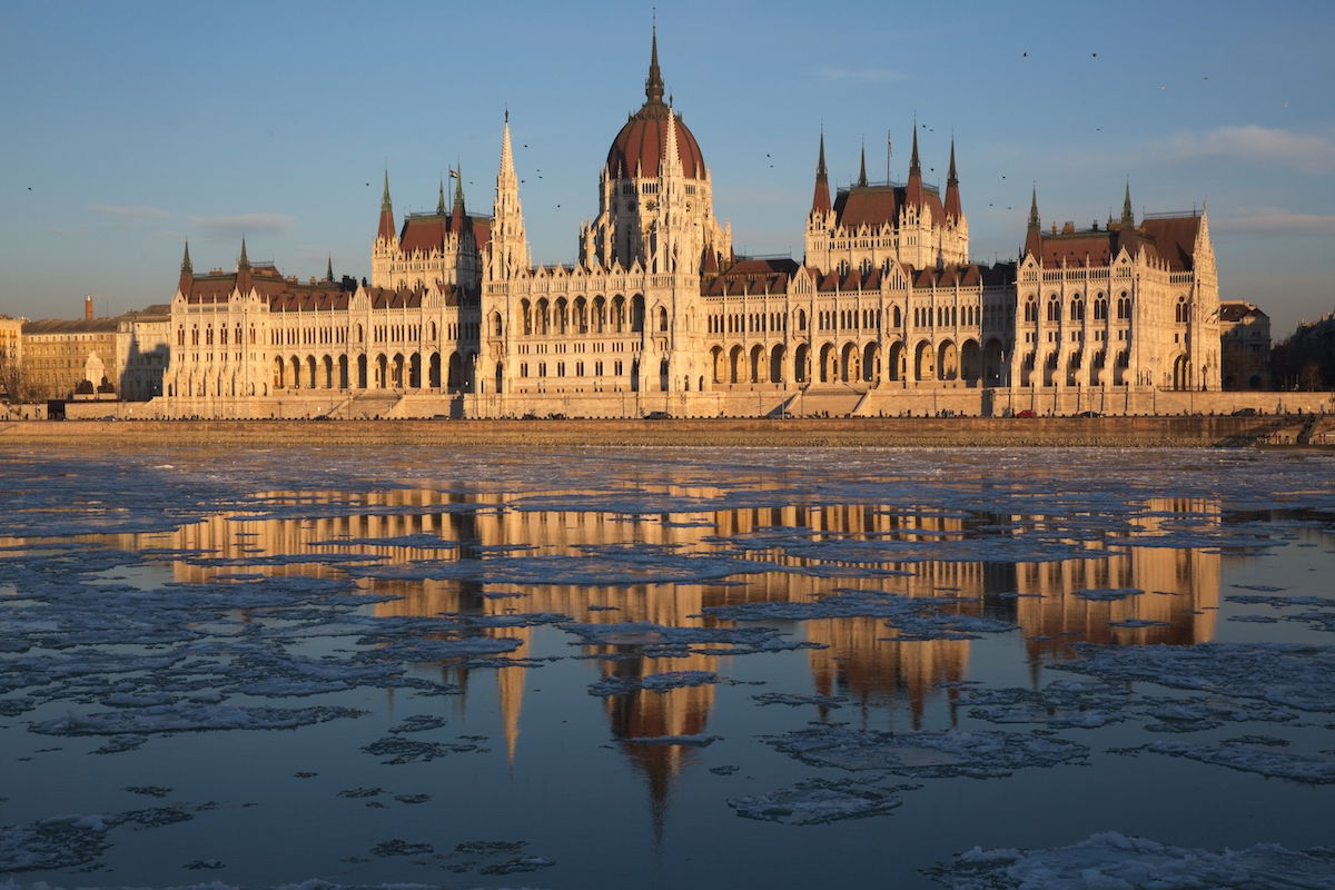 Unedited image of old government building with river reflection at golden hour