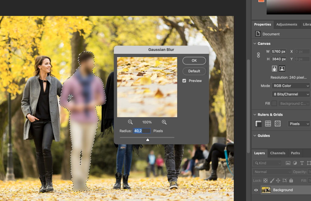 A photo editing interface with a yellowish fall scene in the background.