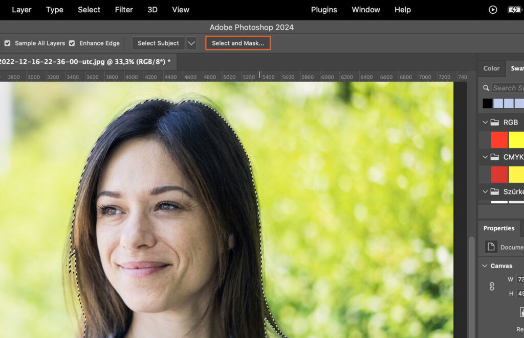 A woman with brown hair smiling at the camera in a photo editing software screen. 