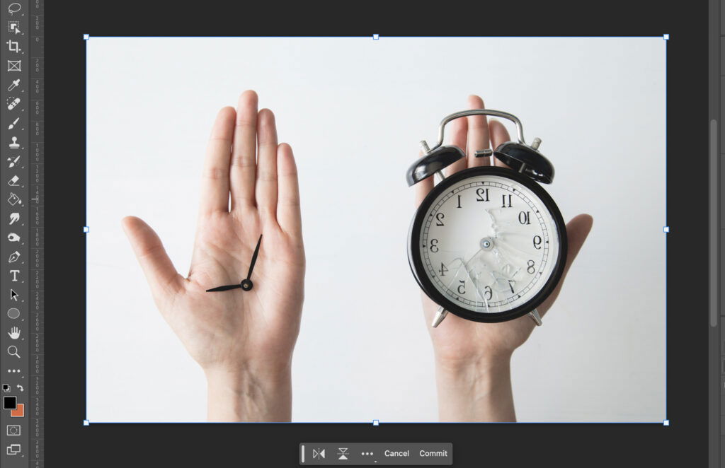 A hand holding two clocks, one on each side.