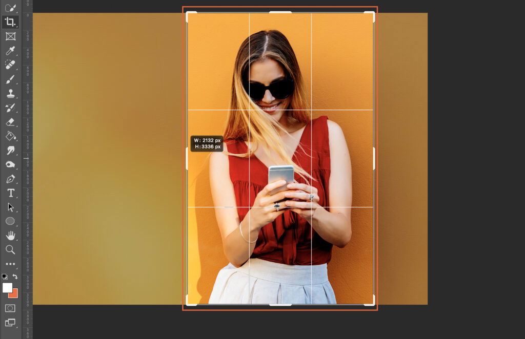 A woman holding a cell phone, with an overlaid Photoshop interface. 