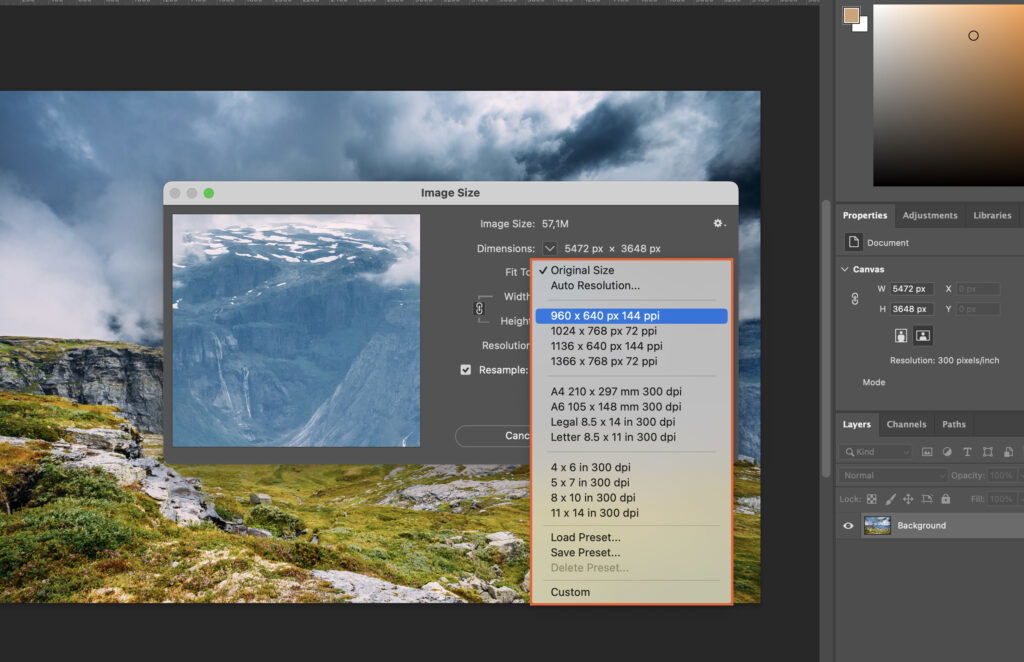 Photoshop program displaying a mountain landscape photo on the canvas and numerous options and settings visible in the interface. 