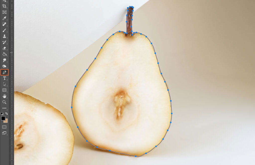 A half peeled pear is being measured by digital tools, with a cutout circle around it. 