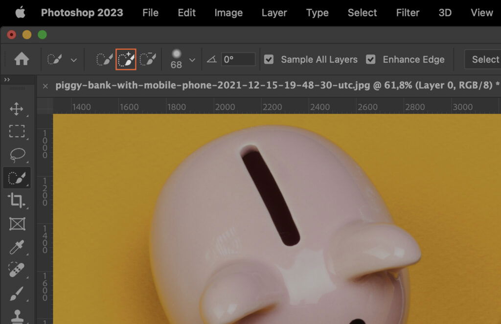 Adobe Photoshop program interface displaying a picture of a piggy bank with the money missing, with various editing options and tools visible around it. 