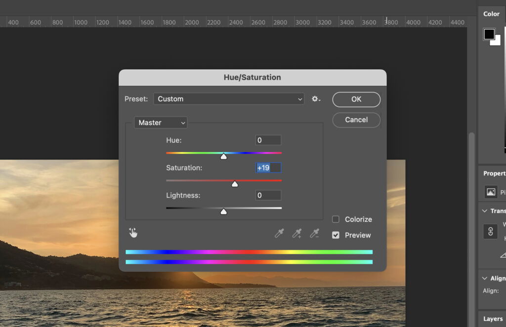 The Photoshop interface displaying a photo of a sunset with the softwares window open and in focus, showing its color settings with preset hues selected. 