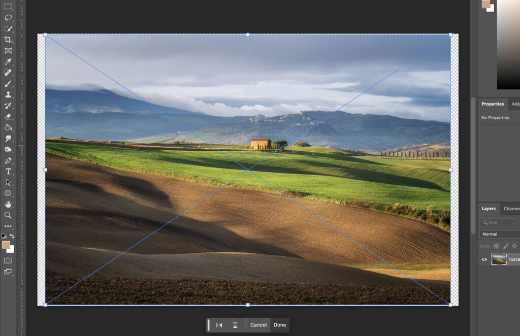 A digital artwork of a countryside landscape, showing an open field under a cloudy sky, with mountains in the distance. 