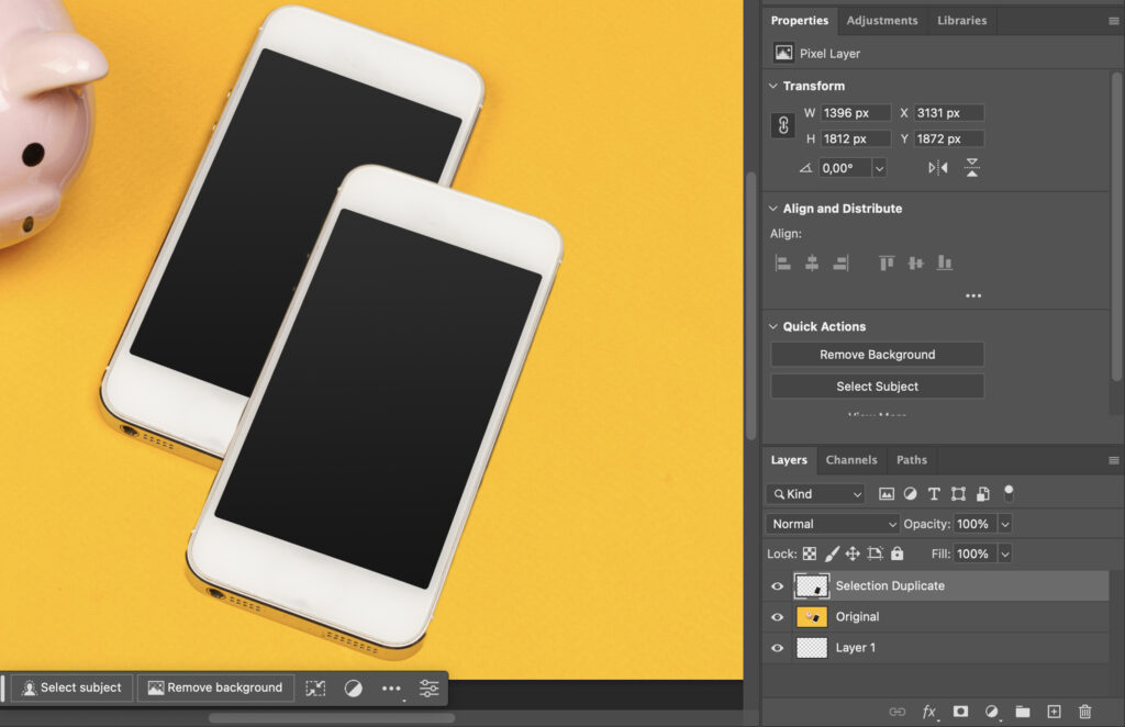 A pair of smartphones resting side by side on a table with a yellow background.