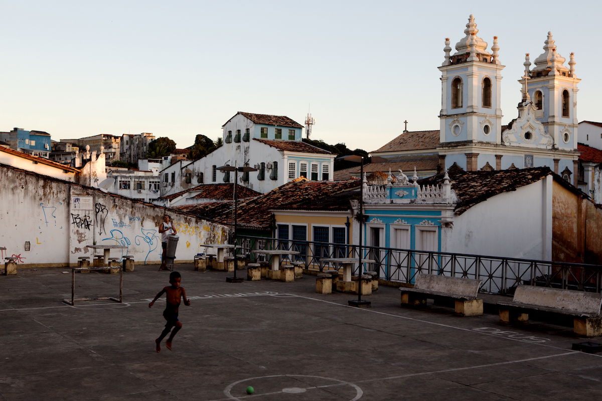 Image of boy playing in a courtyard beside a church with Blacks at 30 in AfterShot Pro 3