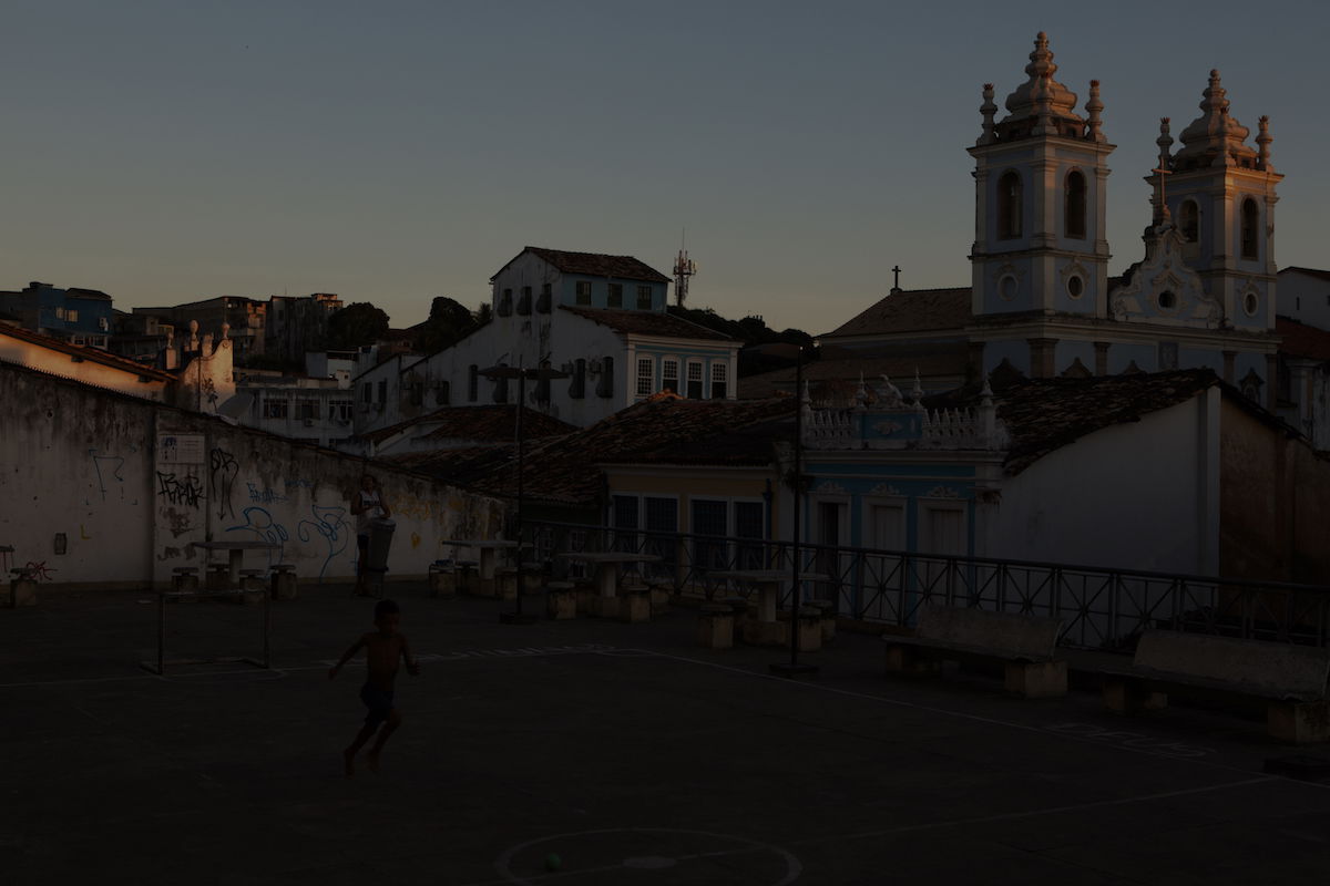 Image of boy playing in a courtyard beside a church at -4 exposure in AfterShot Pro 3