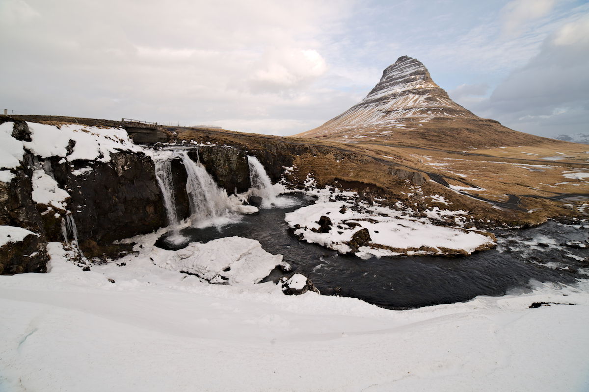 Snowy landscape with a waterfall and green mountain in the distance edited in AfterShot Pro 3