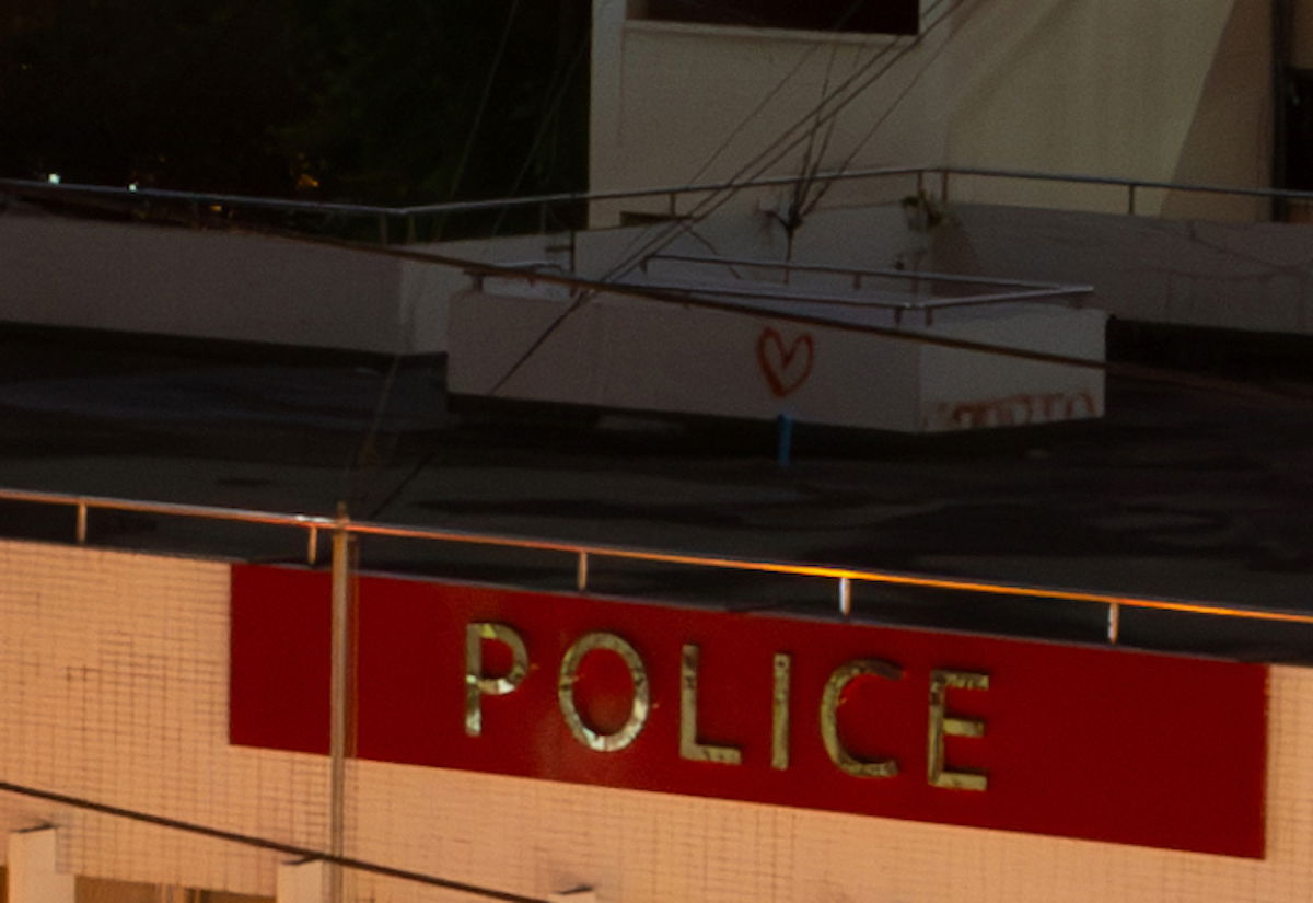 Image of rooftop and police sign with Lightroom denoise