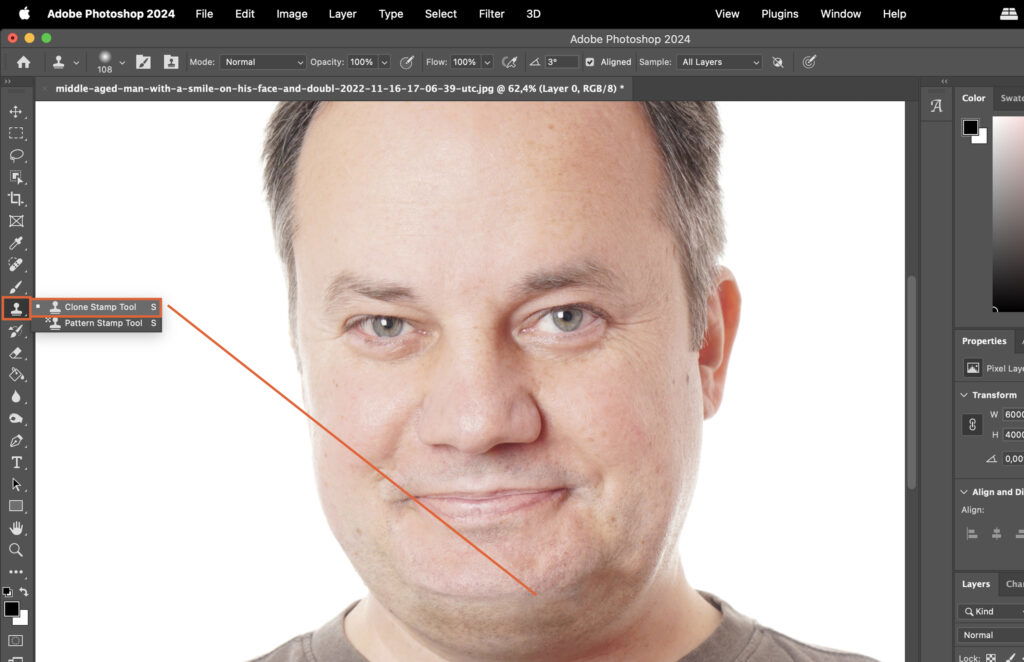 A photo editing software with a blurred mans face highlighted and an arrow pointing to the mans head.