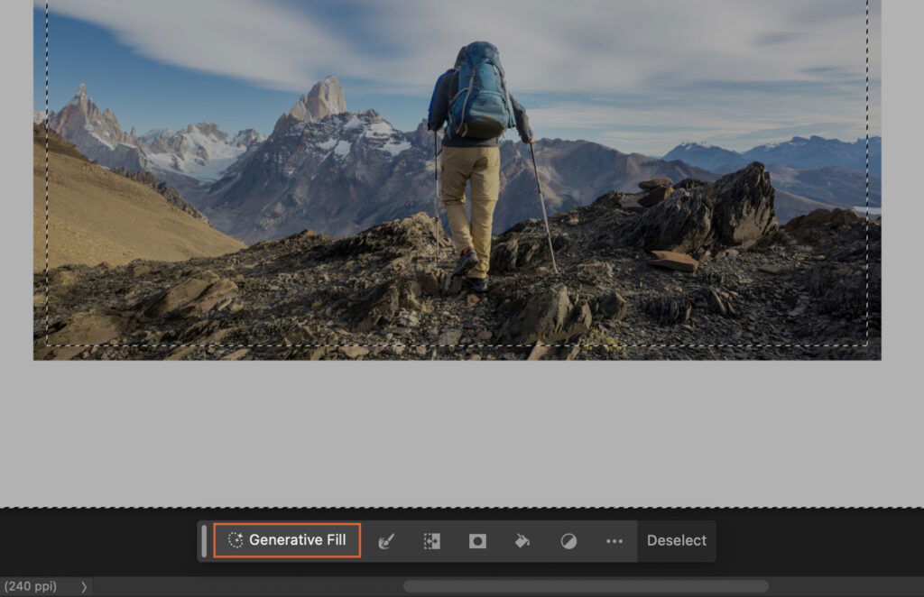 A person hiking in a mountainous landscape, with the background featuring majestic mountains under a clear sky. 