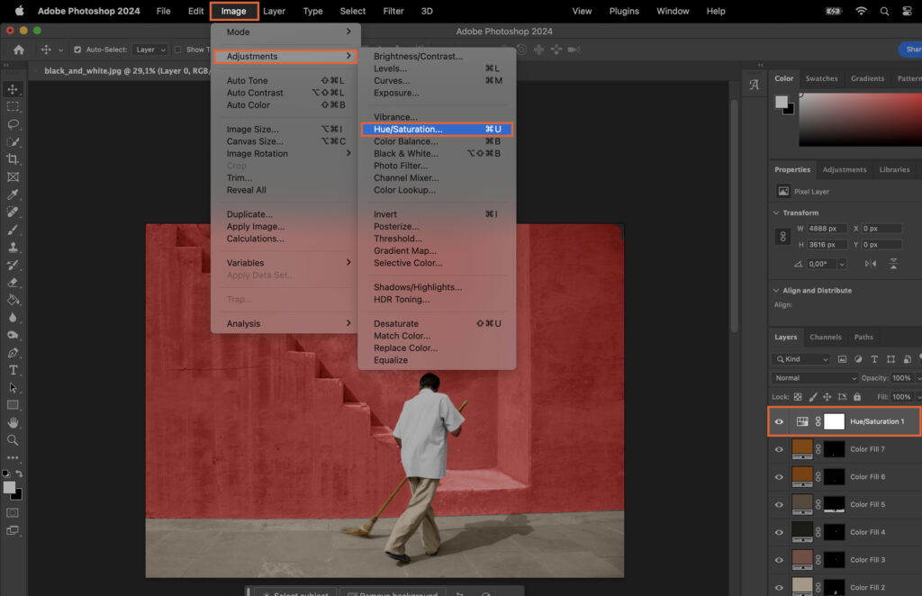 Adobe Photoshop, showing an open document with a man in the center wearing a white shirt and standing next to a red wall. 