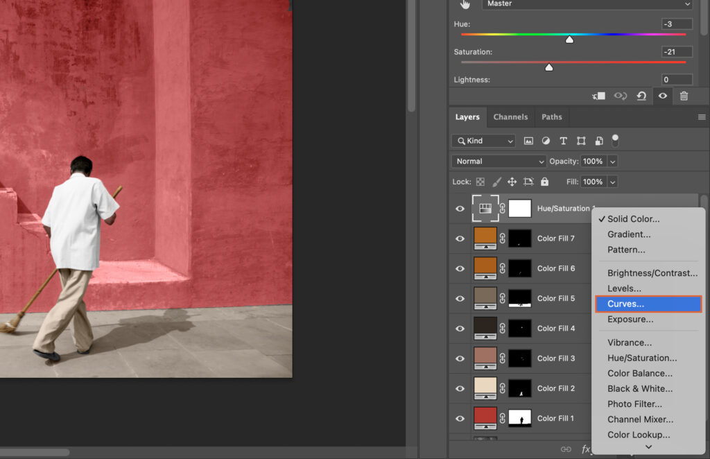 Adobe Photoshop, showing a man in white working on an image. 