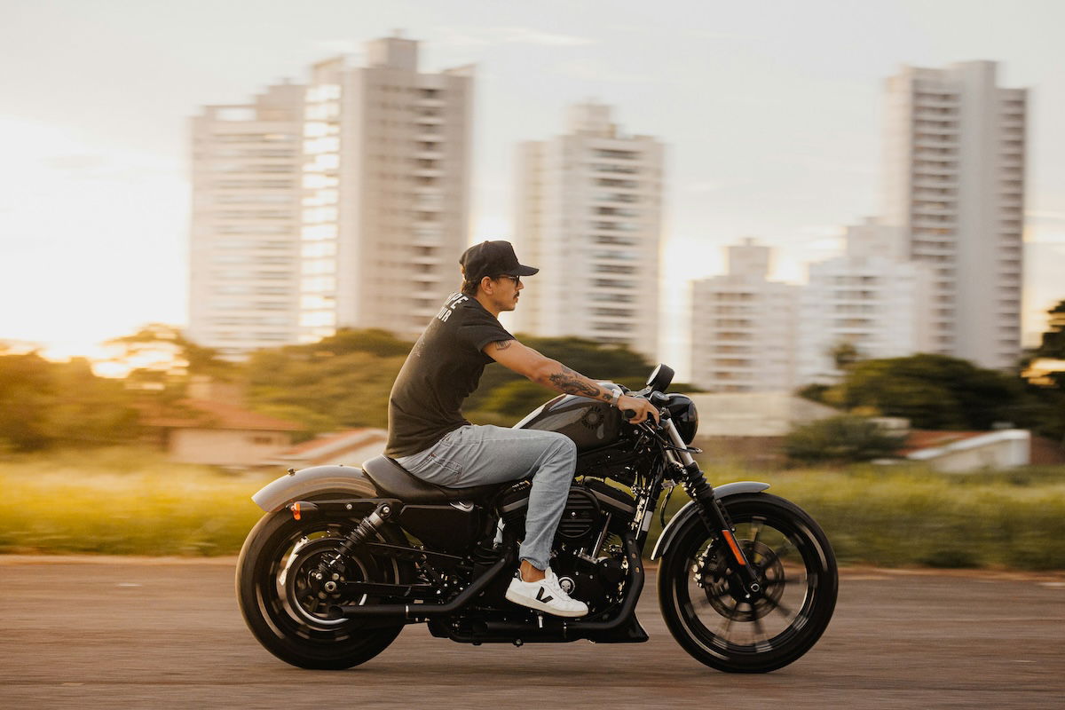 A panning shot of a motorcyclist with background blur taken with an f/5.6 aperture