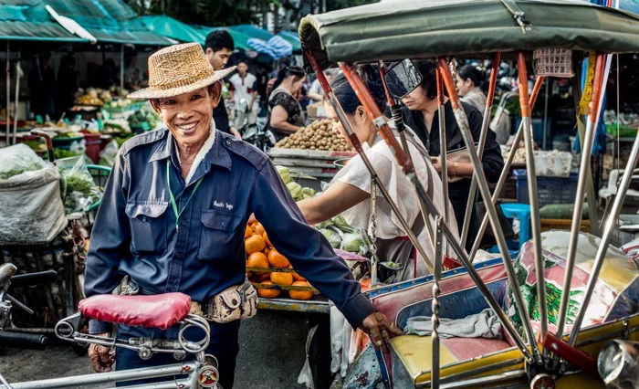 Tricycle taxi driver taking a break