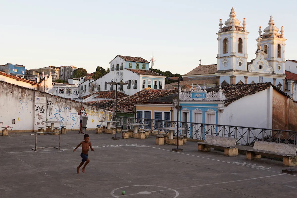 Capture One RAW image of a boy playing in an urban courtyard in front of a church