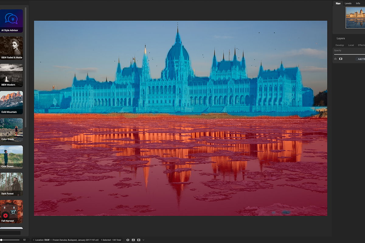 Blue highlighted old government building with river reflection at golden hour