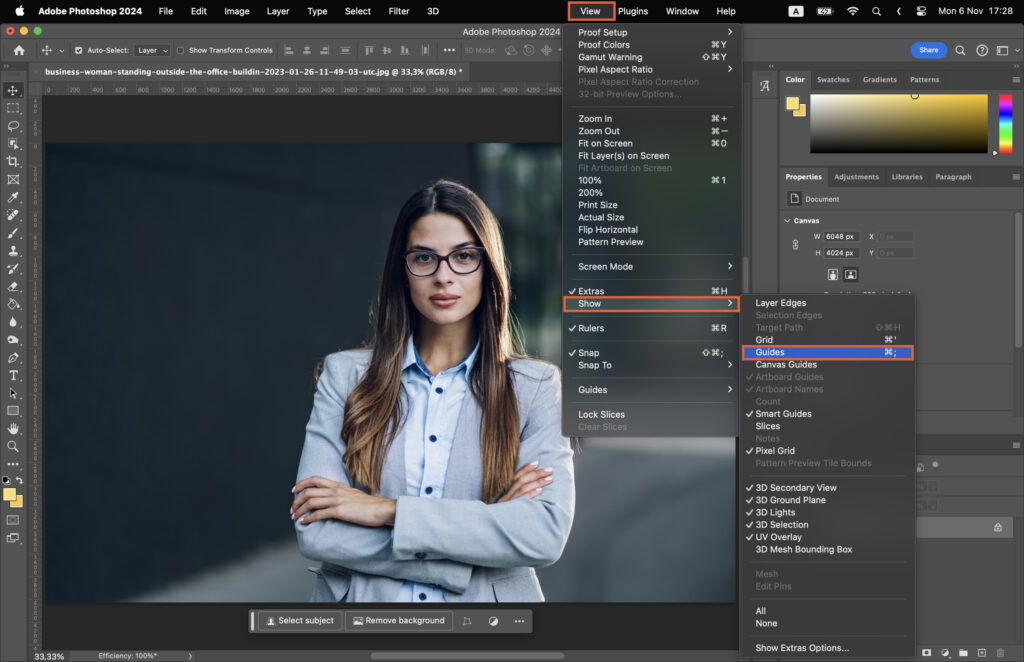 An Adobe Photoshop workspace where the user is working on a photo editing project, featuring a woman posing for a portrait and various tools used in the software. 