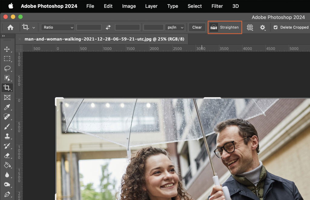 A man and woman sharing an umbrella on a rainy day.