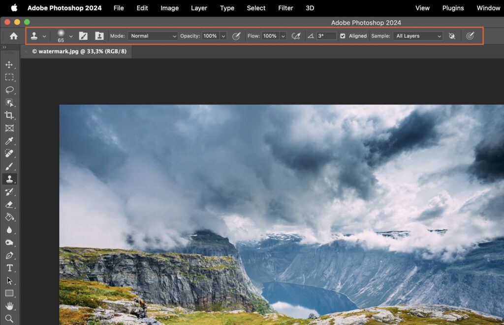 The Adobe Photoshop interface, displaying a digital composition of a mountainous landscape. 