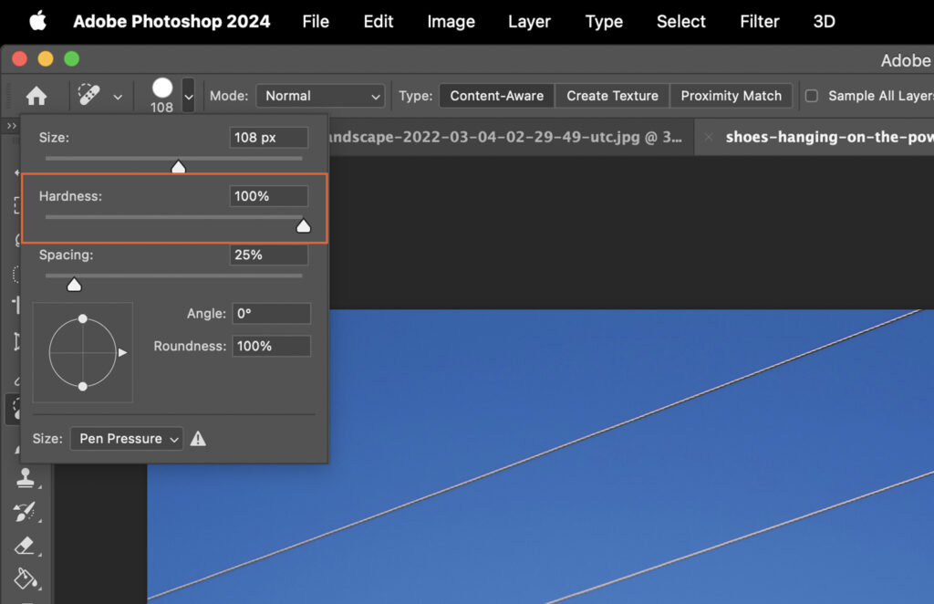 Adobe Photoshop application open, displaying a sky and clouds scene. 