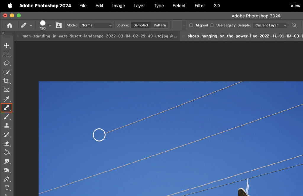 A photo editing software interface displaying a photo of power lines against a blue sky. 